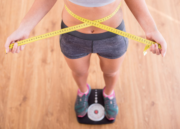 Woman measuring her waist line